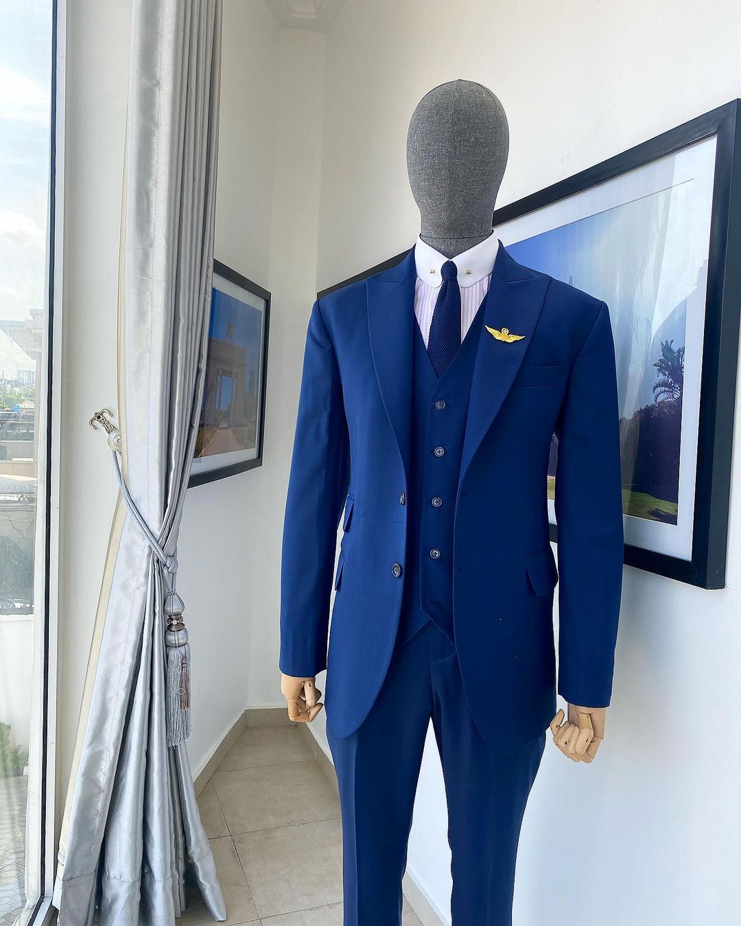 Shop “board room” navy blue peak lapel suit Deji & Kola